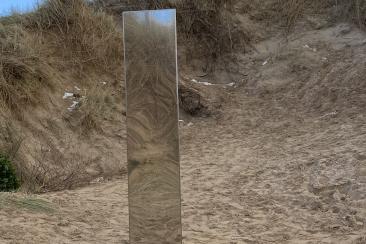 S Facing - Monolith blending in with sand